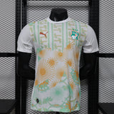 White sports jersey with colorful patterns on a mannequin against a grid background