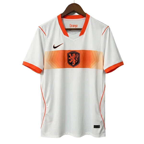 White sports jersey with orange accents on a hanger against a gray background