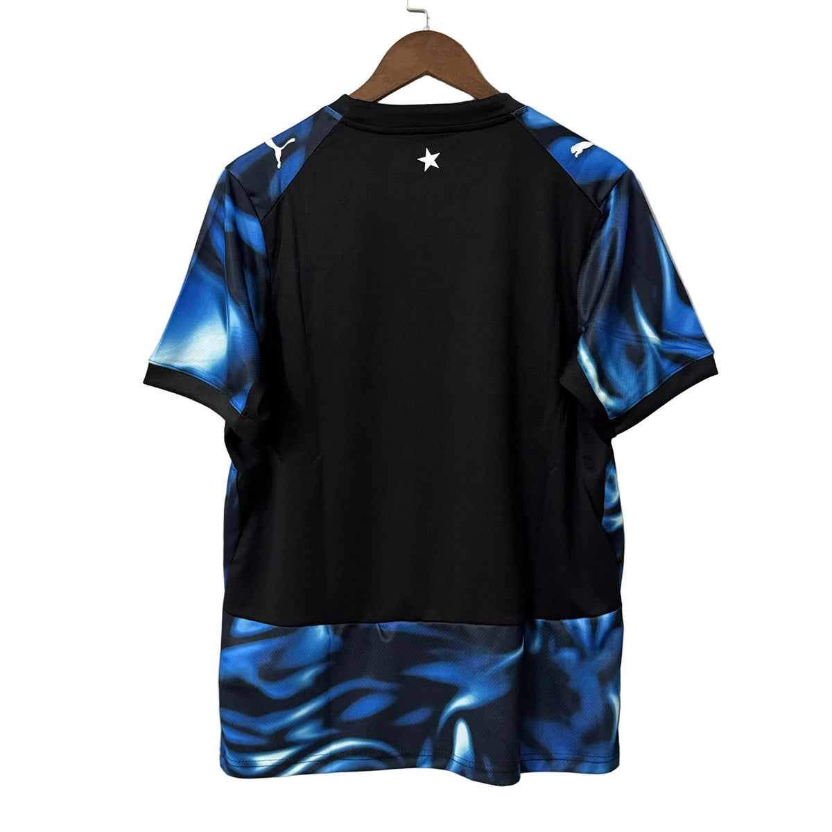 Black and blue sports jersey on a hanger against a gray background