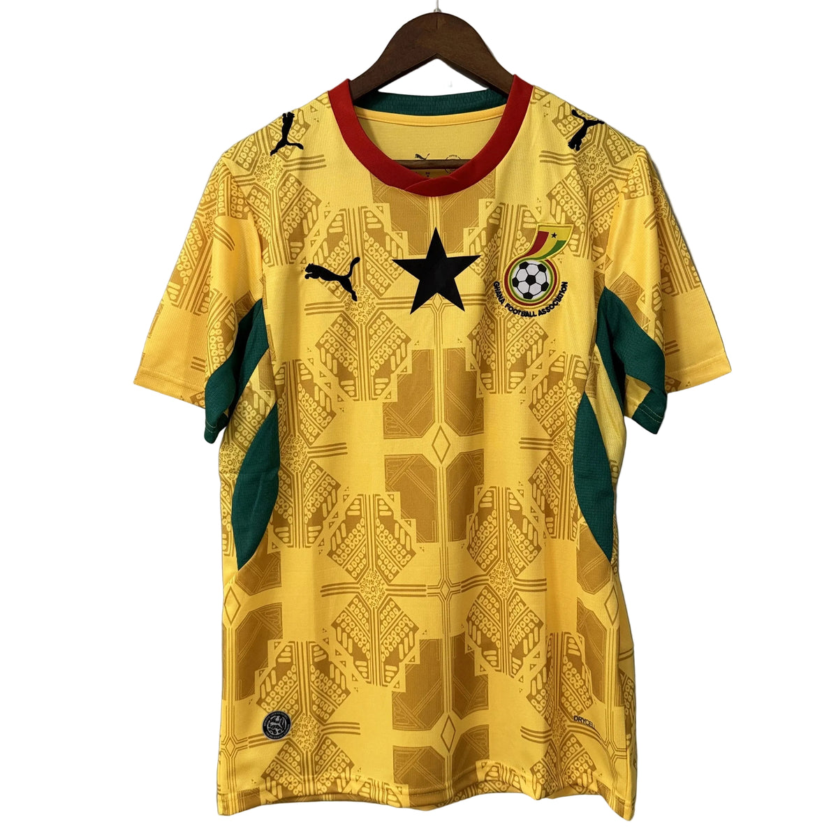 Yellow sports jersey with star and emblem on a gray background
