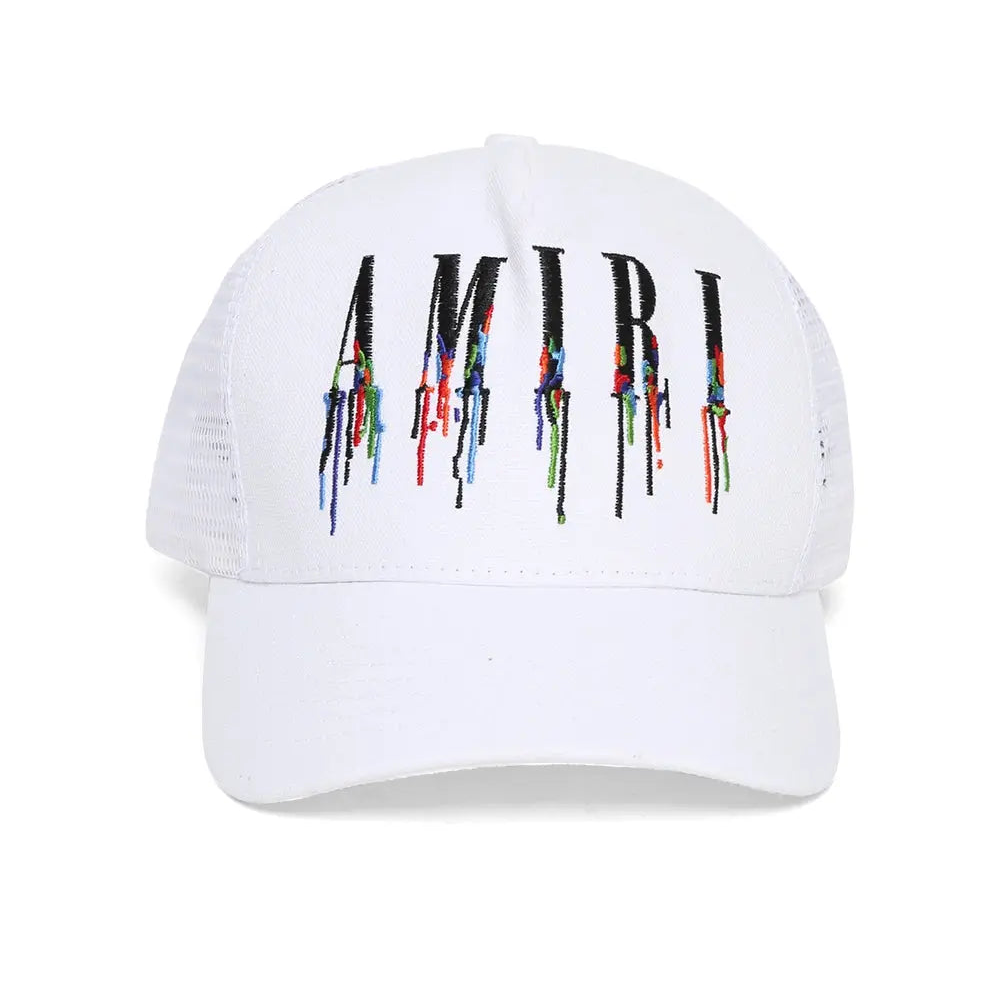 White cap with 'AMIRI' logo featuring colorful paint-like design on a white background
