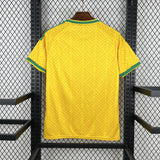 Yellow sports jersey with green accents on a black metal rack.
