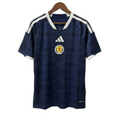 Navy blue sports jersey with white accents on a hanger against a gray background