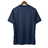 Blue t-shirt on a hanger against a white wall