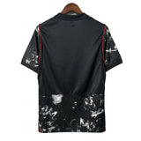 Black shirt with white abstract pattern on a hanger against a gray background