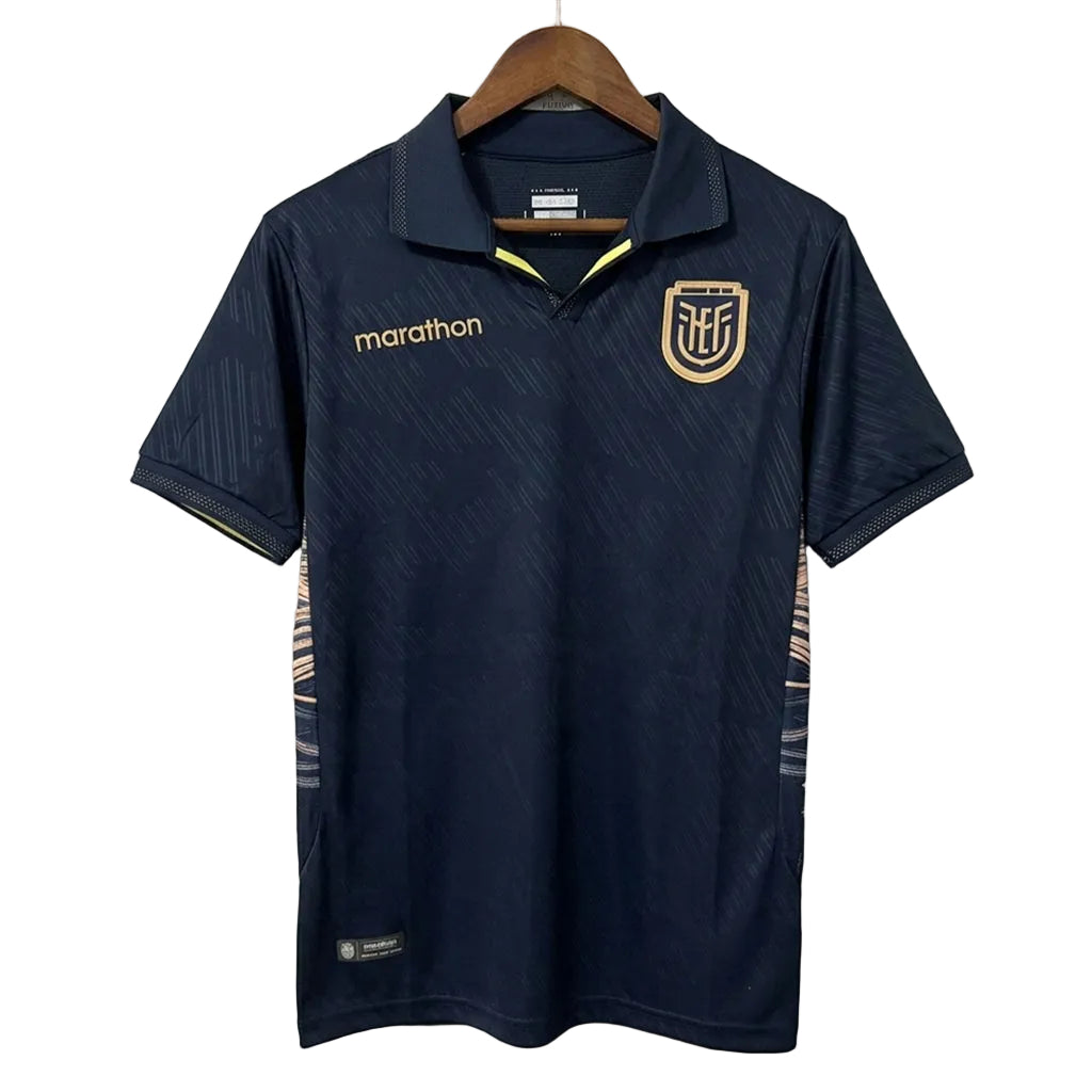 Navy blue sports shirt with logos on a hanger against a light gray background